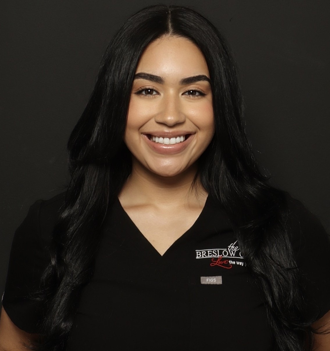 Smiling woman in a black uniform.