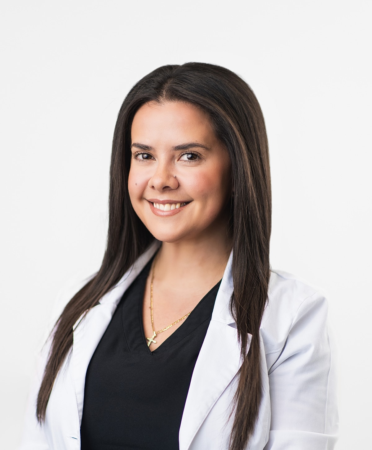 Smiling woman in medical lab coat portrait.