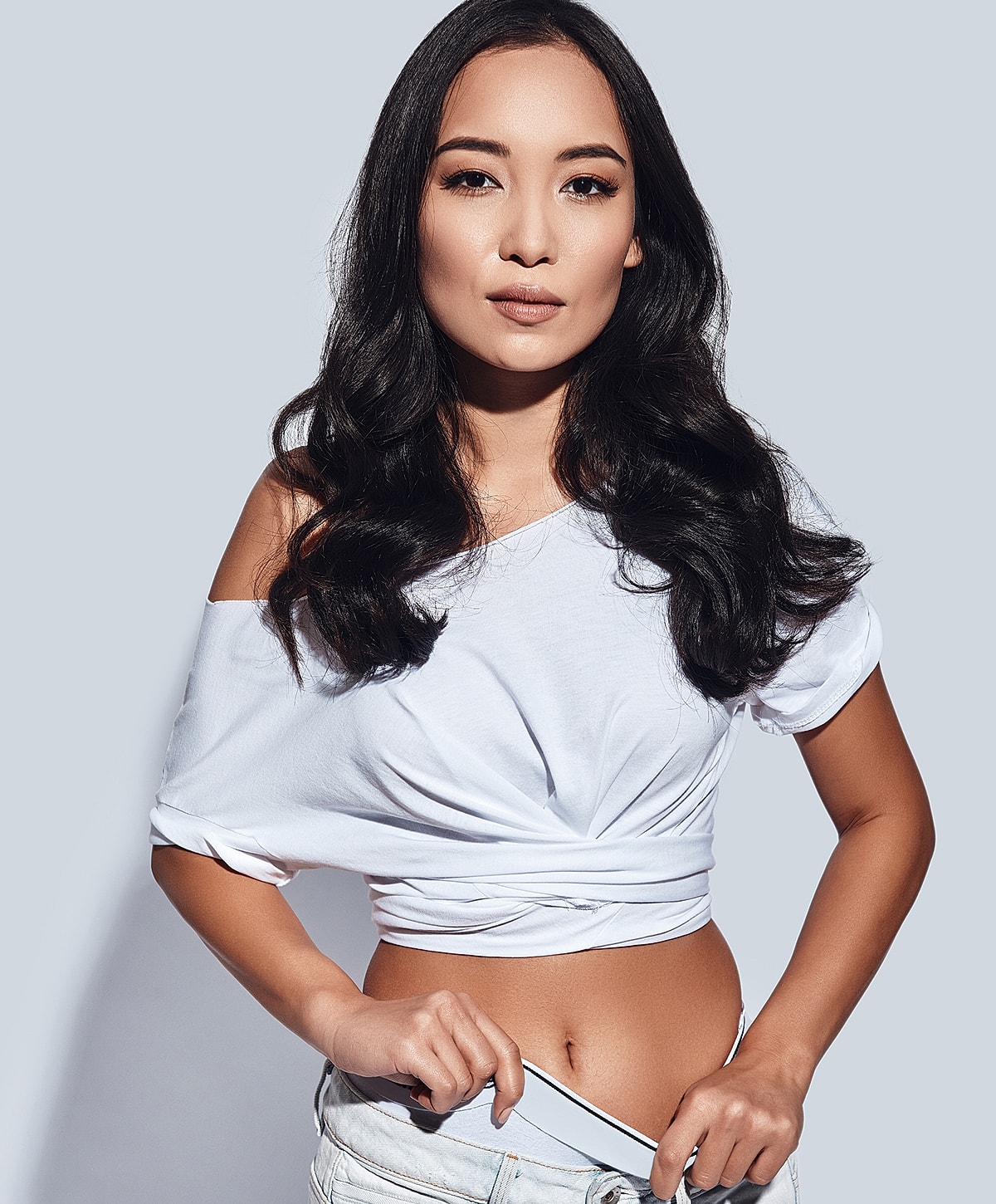 Woman in stylish outfit, posing confidently.