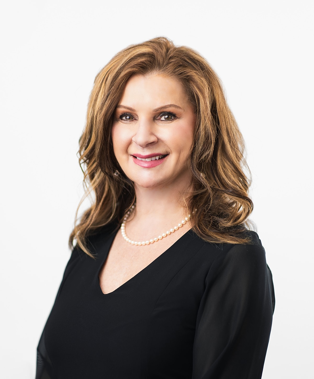 Professional woman smiling in a black outfit.