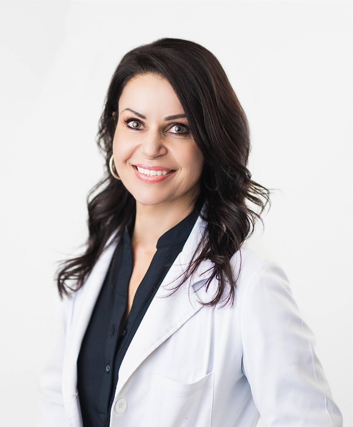 Smiling professional in a white lab coat.