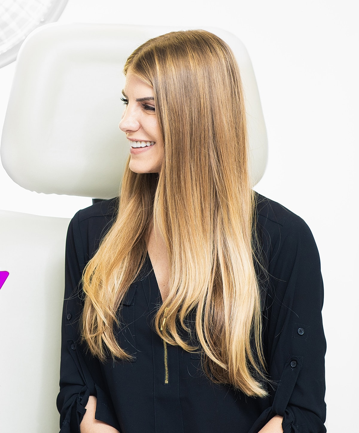 Woman smiling with long, straight, blonde hair.