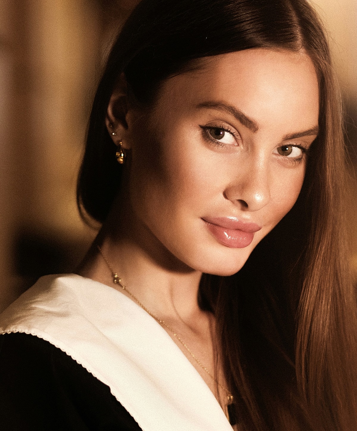 Young woman with long hair and subtle makeup.