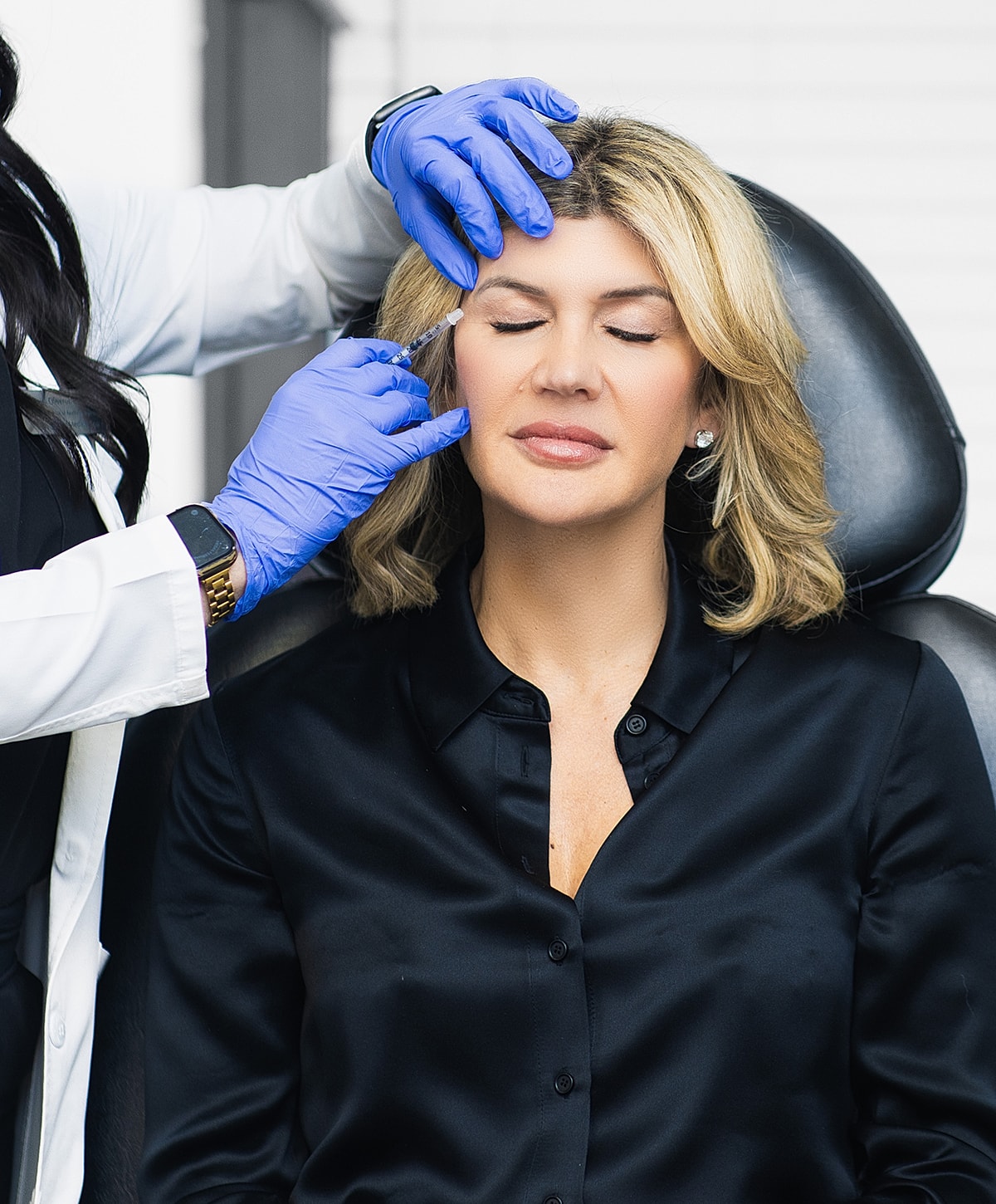 Patient receiving cosmetic injection in clinic setting.