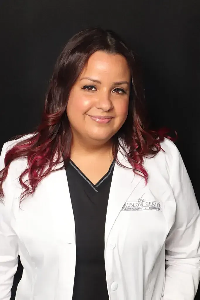 Smiling professional in a white lab coat.