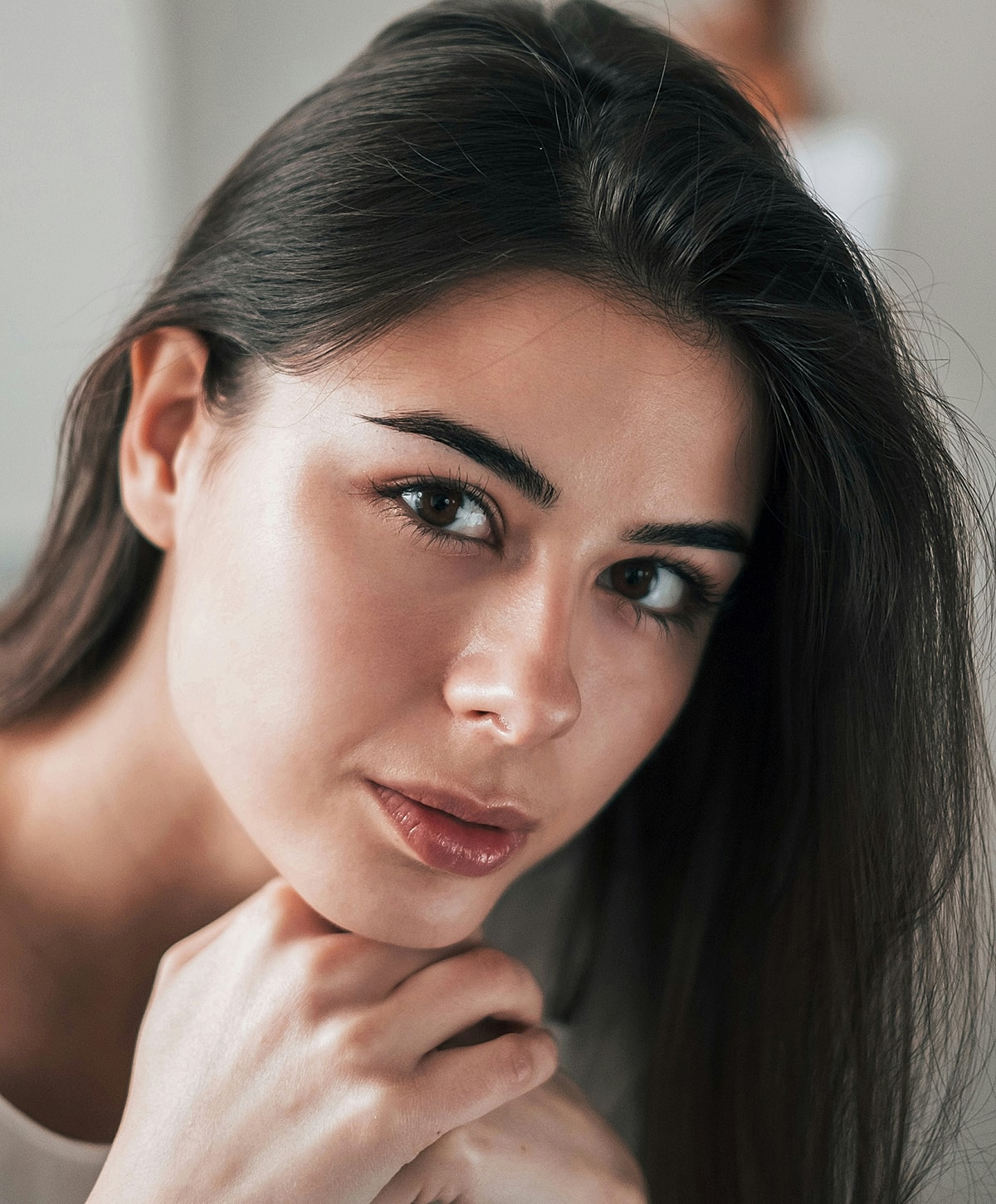 Close-up of a woman with long dark hair.