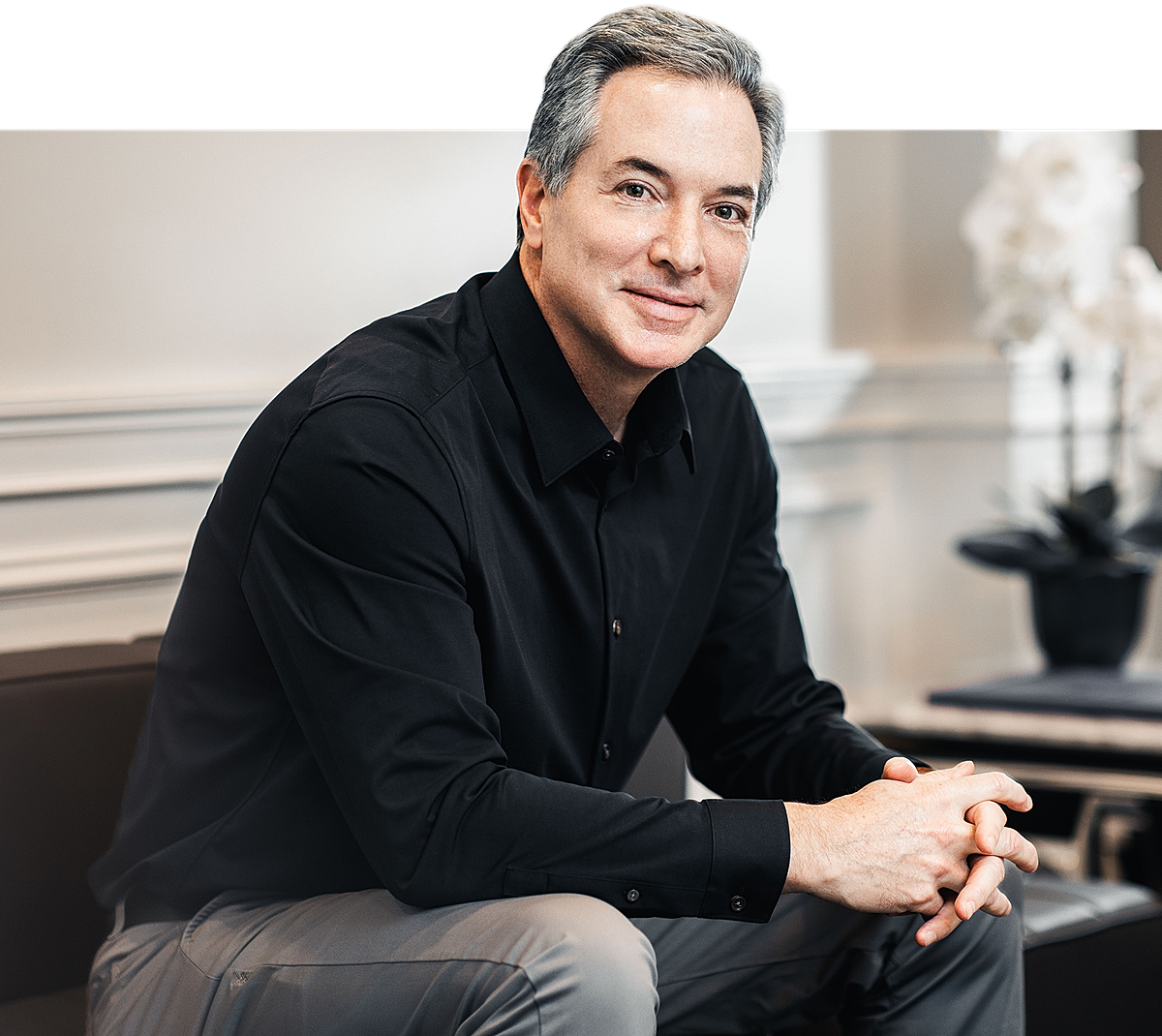 Professional man sitting in a modern setting.