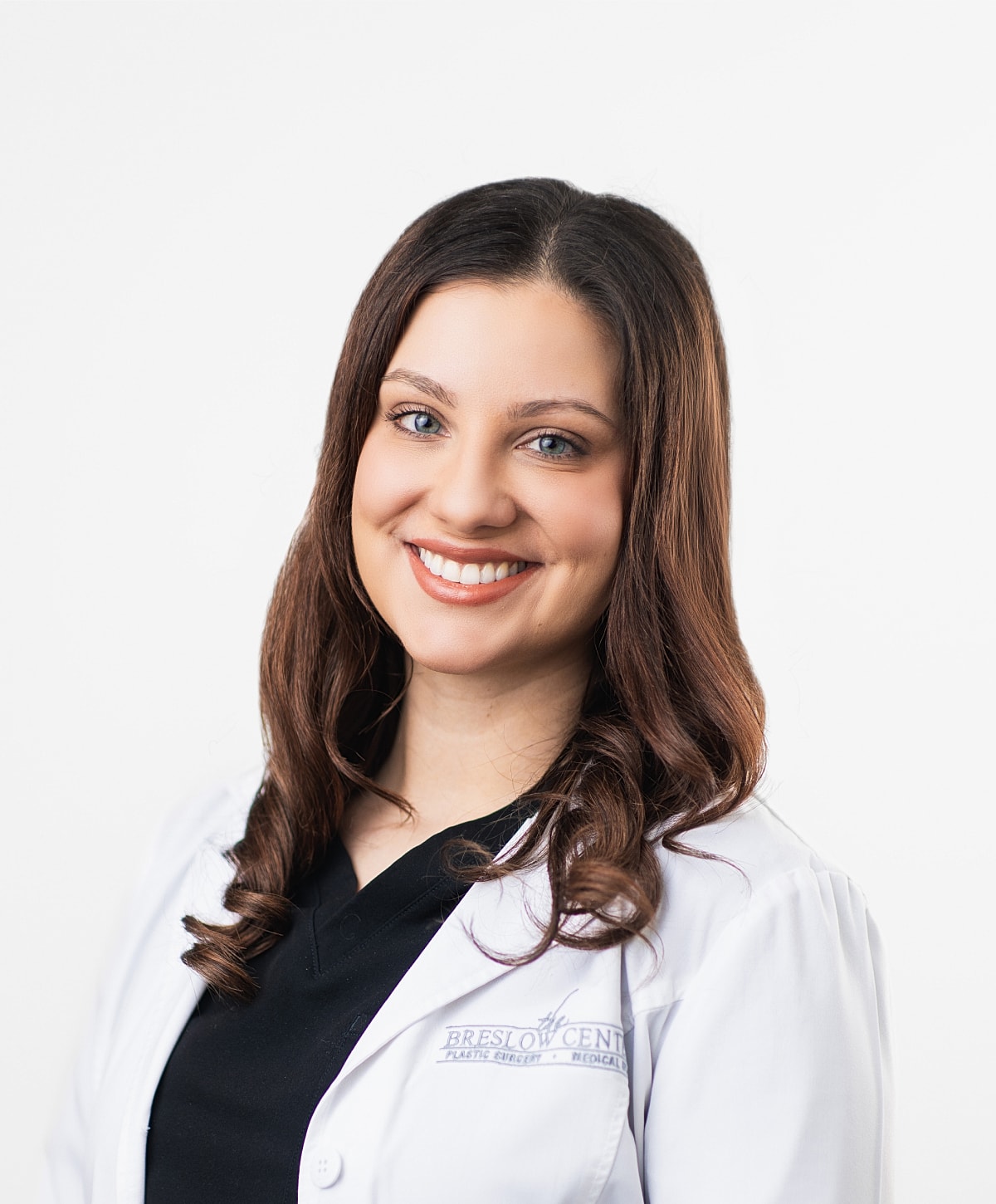 Smiling healthcare professional in white coat.