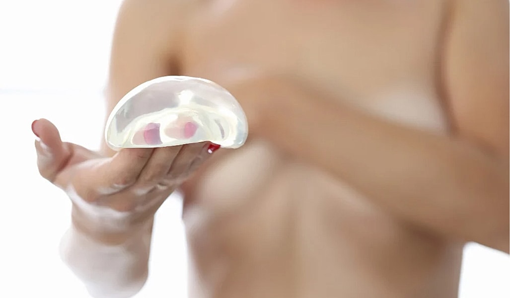 Silicone implant held in hand.