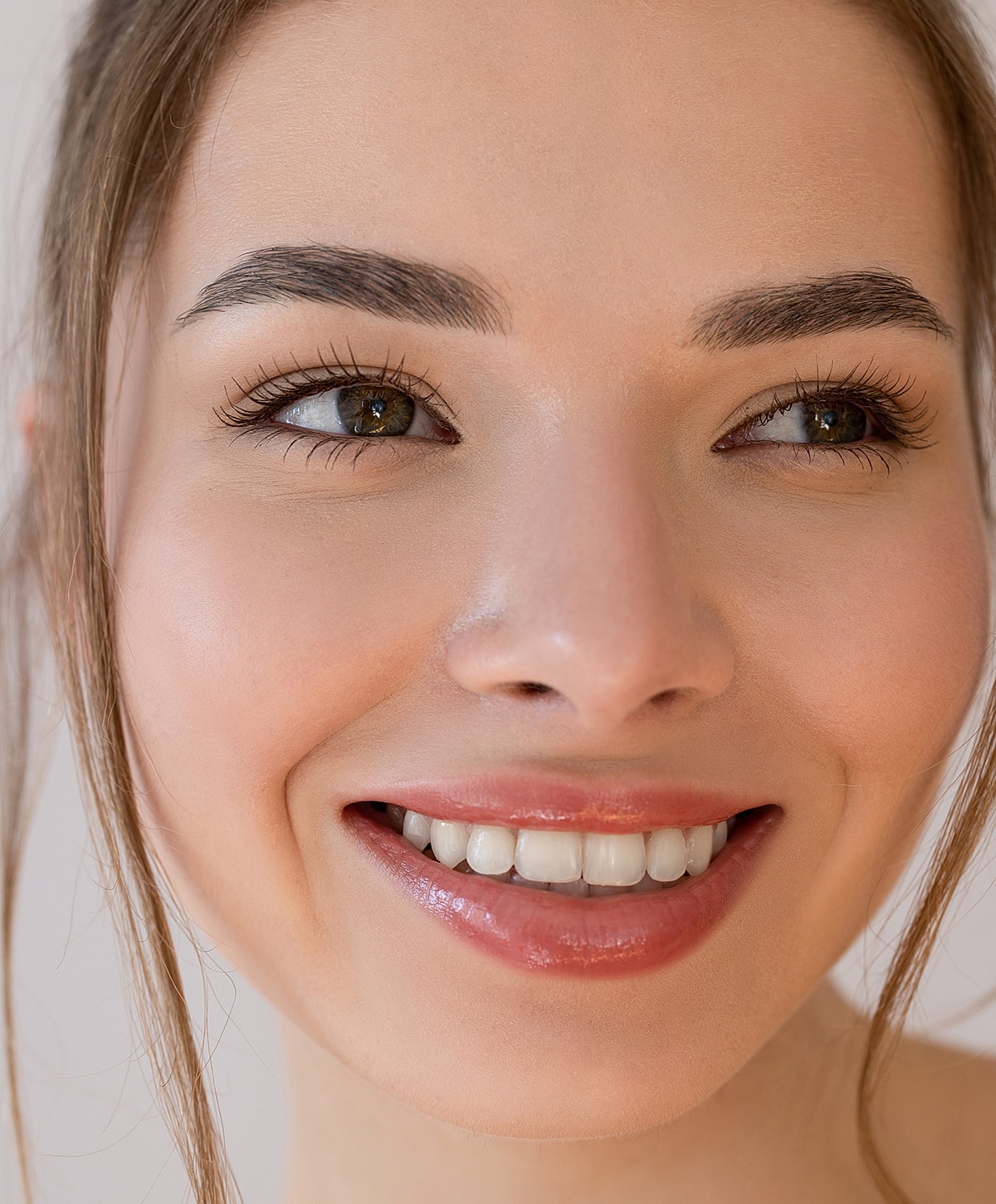 Smiling woman with bright eyes and healthy skin