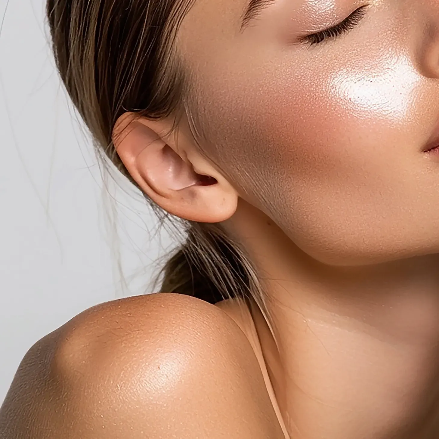 Close-up of glowing skin and relaxed expression.
