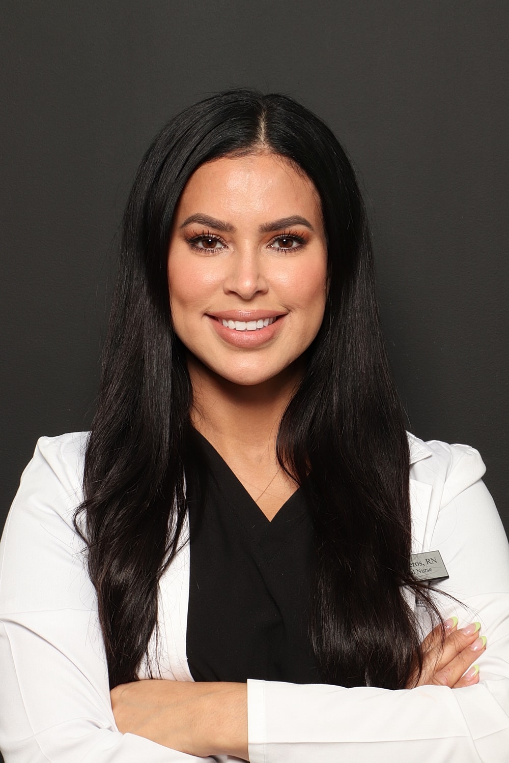 Smiling healthcare professional in a white coat.