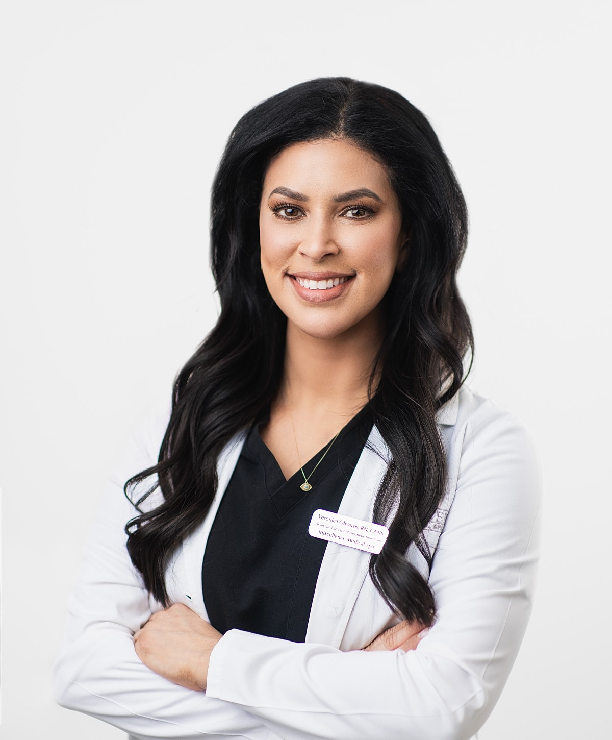Healthcare professional smiling in white coat.