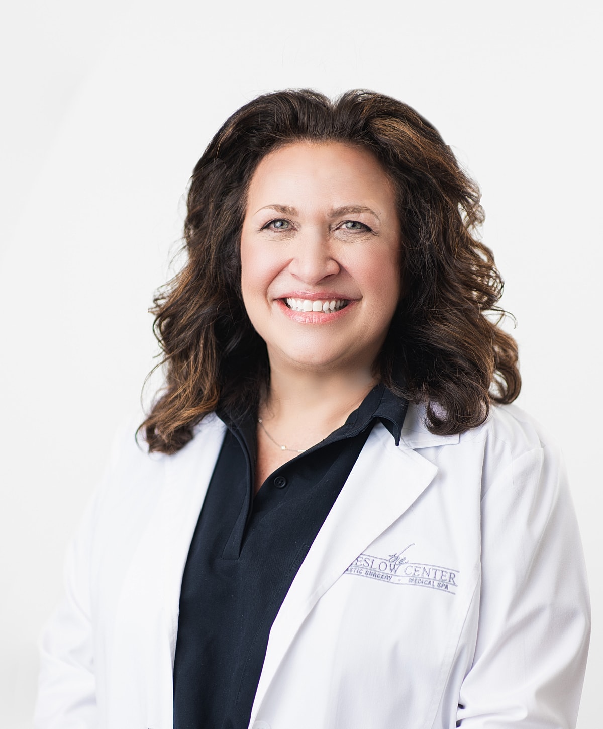 Healthcare professional smiling in lab coat.