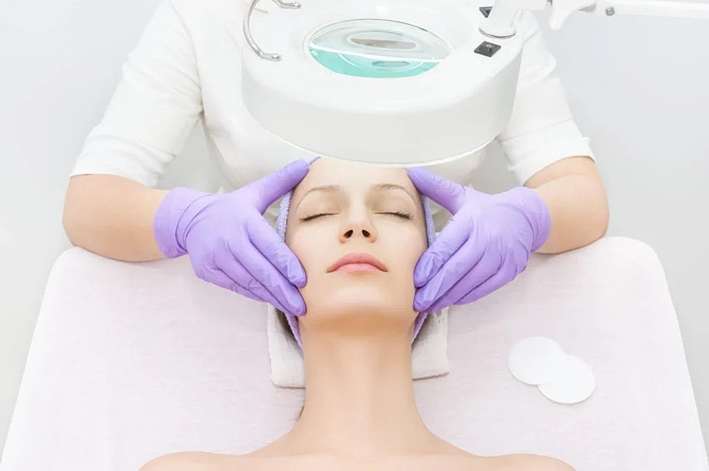 Facial treatment in progress at spa salon.