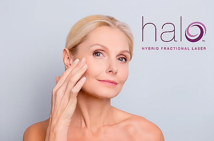 Woman demonstrating skincare with Halo laser treatment.