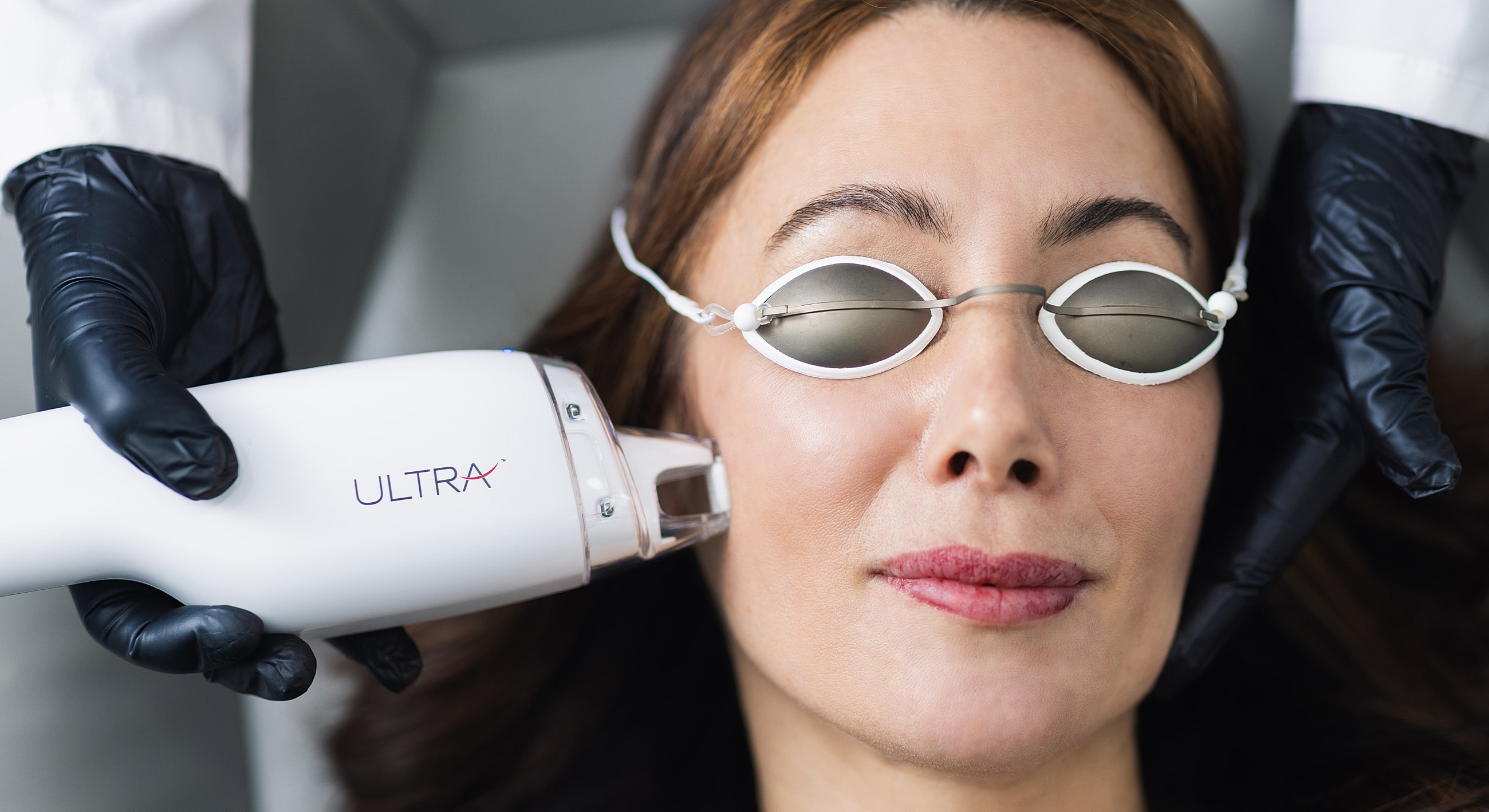 Facial treatment with equipment and protective eyewear.