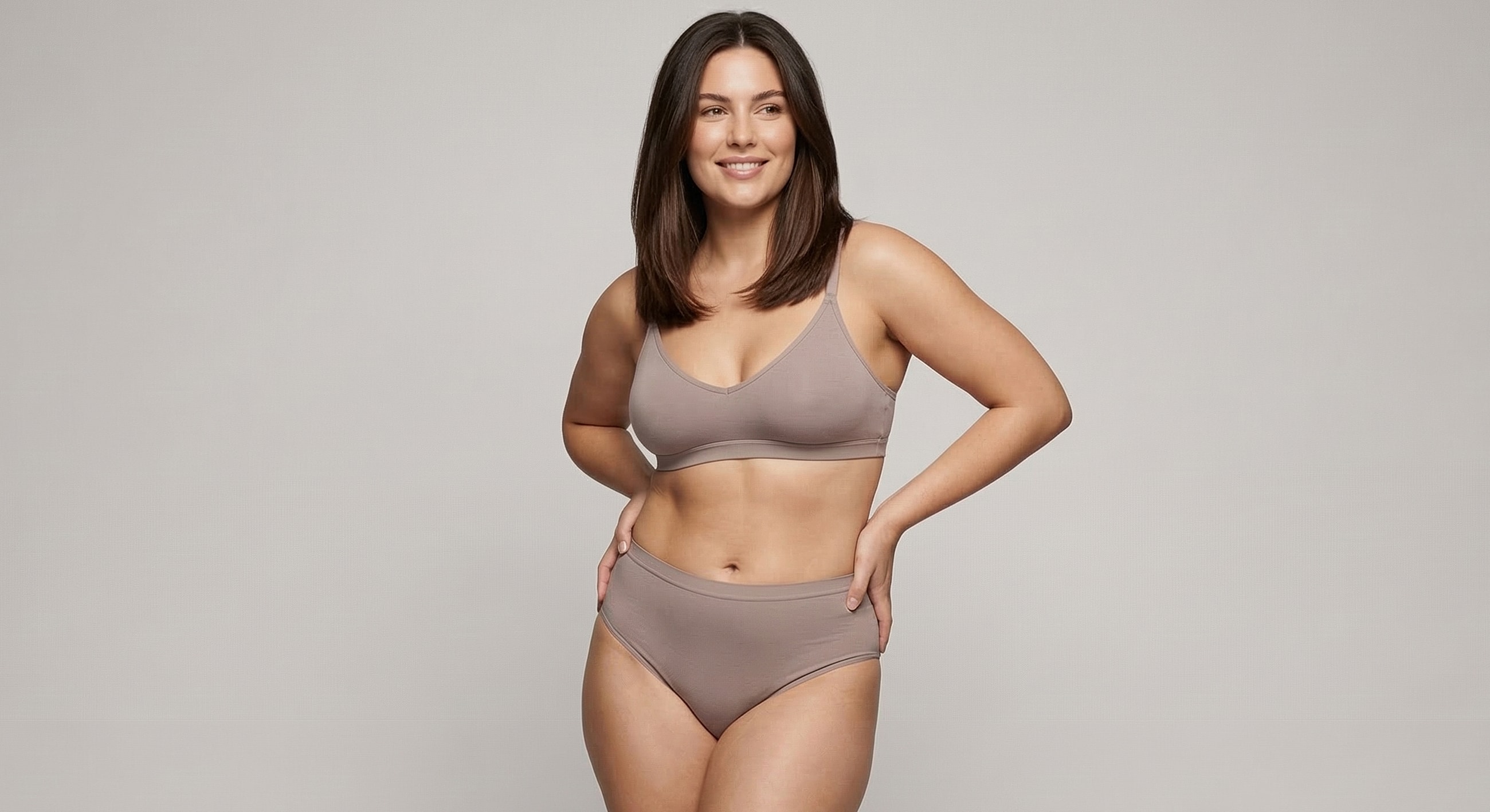 Smiling woman in comfortable lingerie set.