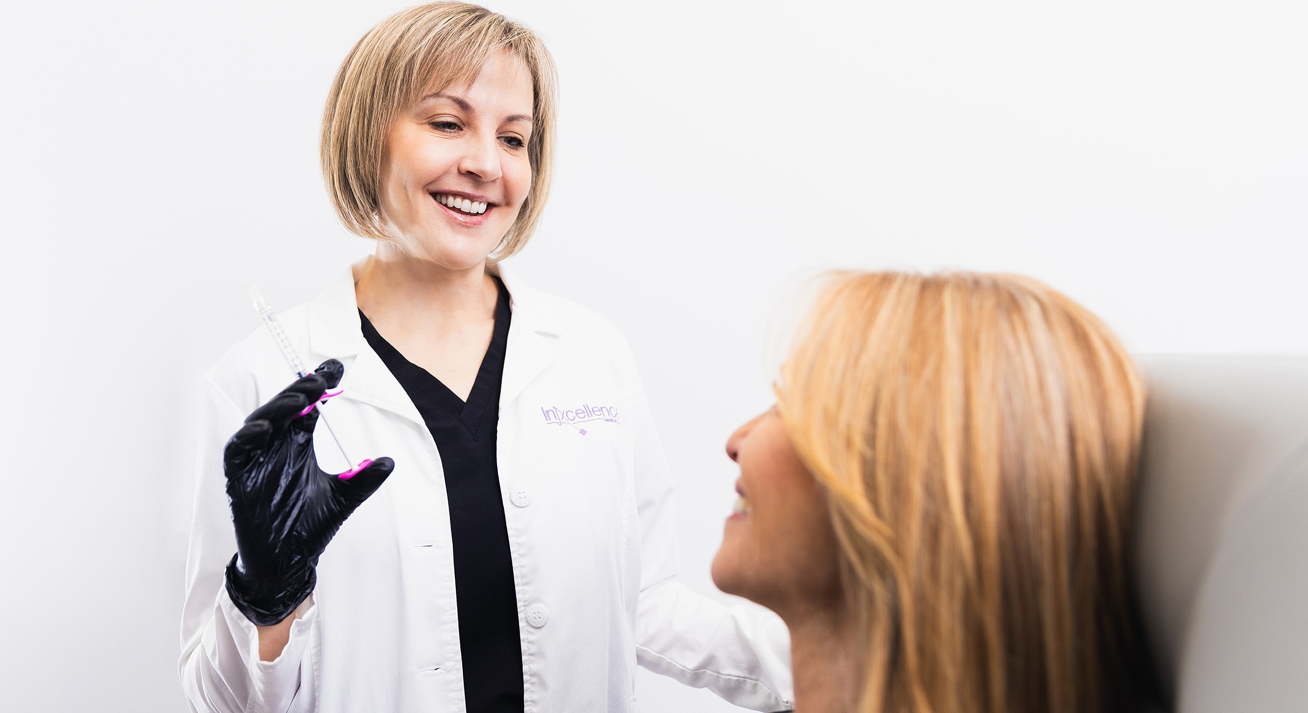 Nurse preparing injection for patient consultation.