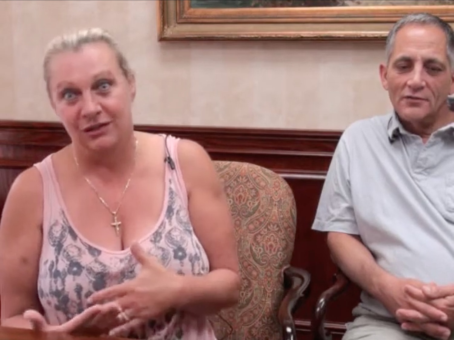 Two people talking in a seated setting.