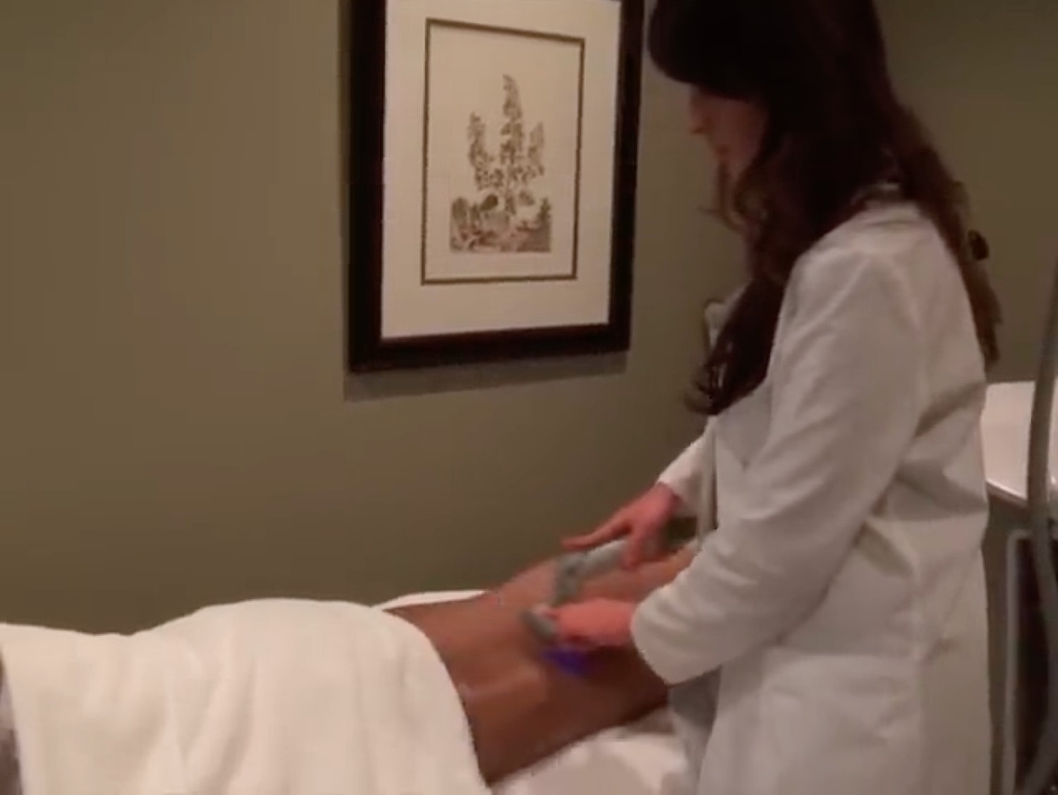 Therapist applying treatment in spa setting.